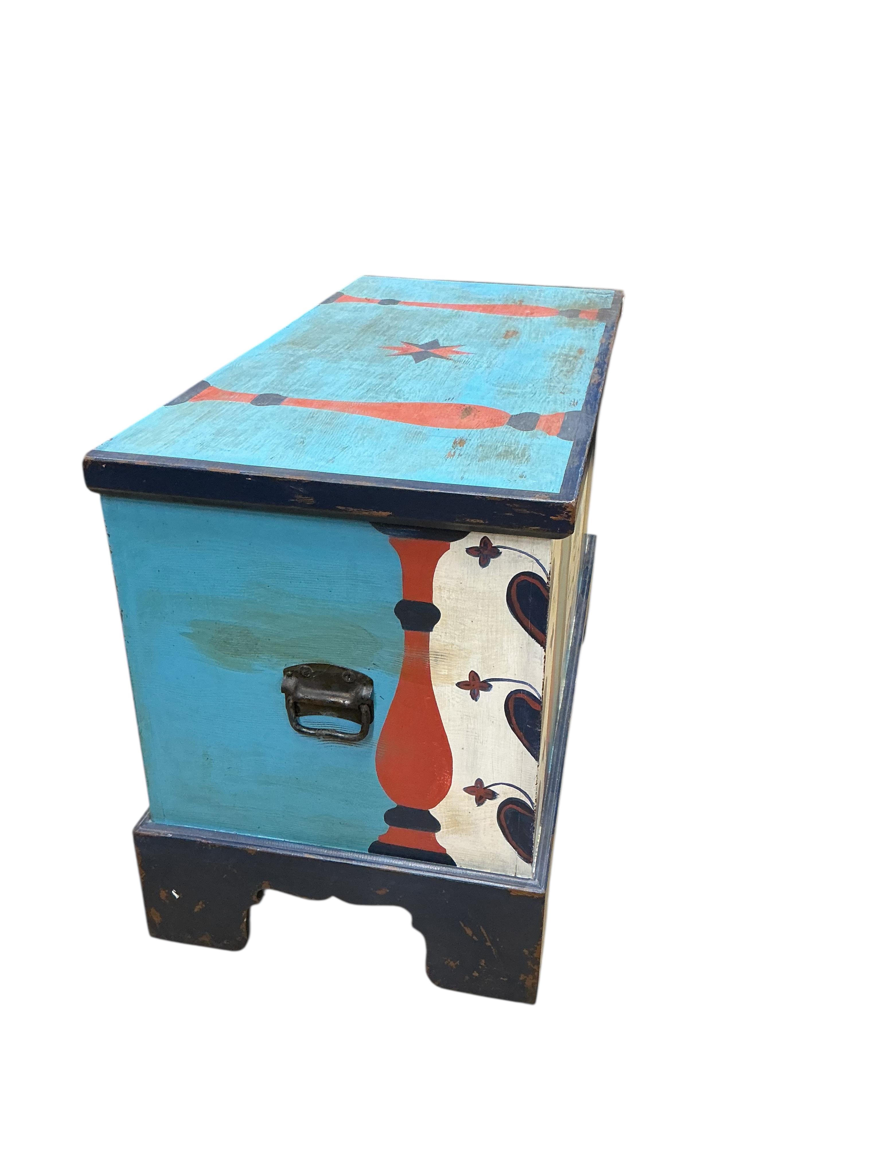 A painted chest, floral decorated and inscribed, width 102cm, depth 49cm, height 67cm